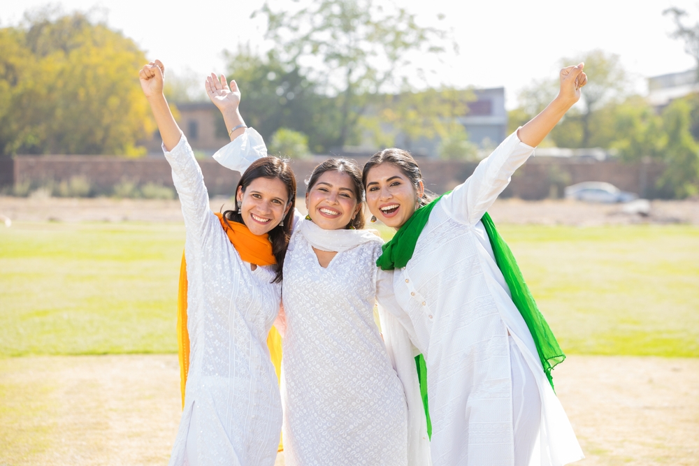 Young,happy,indian,women,wearing,white,kurta,dress,with,tricolor